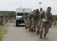 Gunery Sgt. John Schmuck, Company Gunnery Sergeant, Headquarters and Support Company, Chemical Biological Incident Response Force, leads H&S Company’s team in the truck pull during CBIRF’s battalion field meet 24 May. Headquarters and Support Company, IRF A and IFR B all competed against one another in several events to strengthen unit cohesion after the safety brief before the Memorial Day weekend.