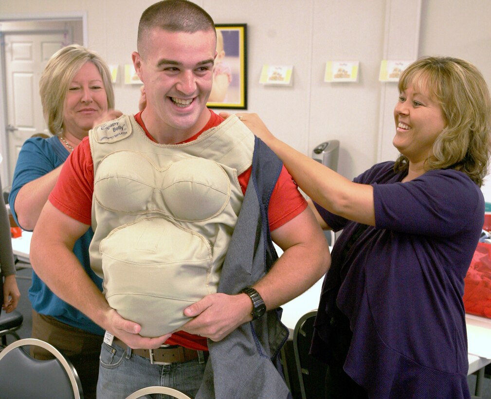 Cpl. Richard Sherin, a Casualty Cell clerk with II Marine Expeditionary Force, tries on a pregnancy vest during Baby Boot Camp, May 24, 2011, at the Midway Park Marine & Family Services Annex aboard Marine Corps Base Camp Lejeune, N.C. Sherin tried on the vest to get a feel for what his expecting wife is dealing with on a daily basis.