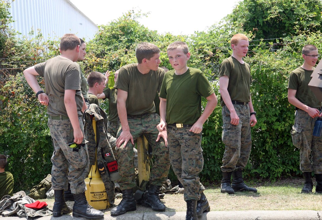 Royal Canadian Army Cadets  take a water break after receiving a class on a light armored vehicle by Marines with 2nd Light Armored Reconnaissance Battalion aboard Marine Corps Base Camp Lejeune N.C., May 25, 2011. The cadets stayed three days aboard the base and participated in various Marine exercises consisting of obstacle courses and the gas chamber.