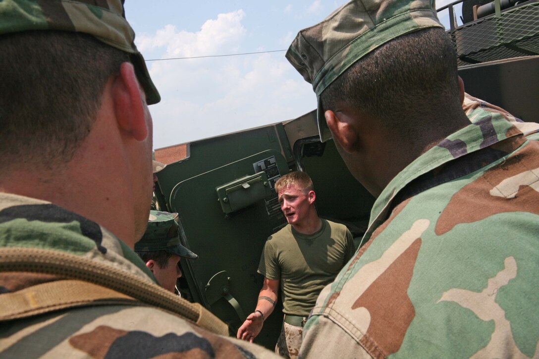 Midshipmen from the United States Naval Academy receive a class on a light armored vehicle by Marines with 2nd Light Armored Reconnaissance Battalion aboard Marine Corps Base Camp Lejeune N.C., May 25, 2011. The midshipmen stayed five days aboard the base and participated in various Marine exercises such as counter improvised explosive device training.