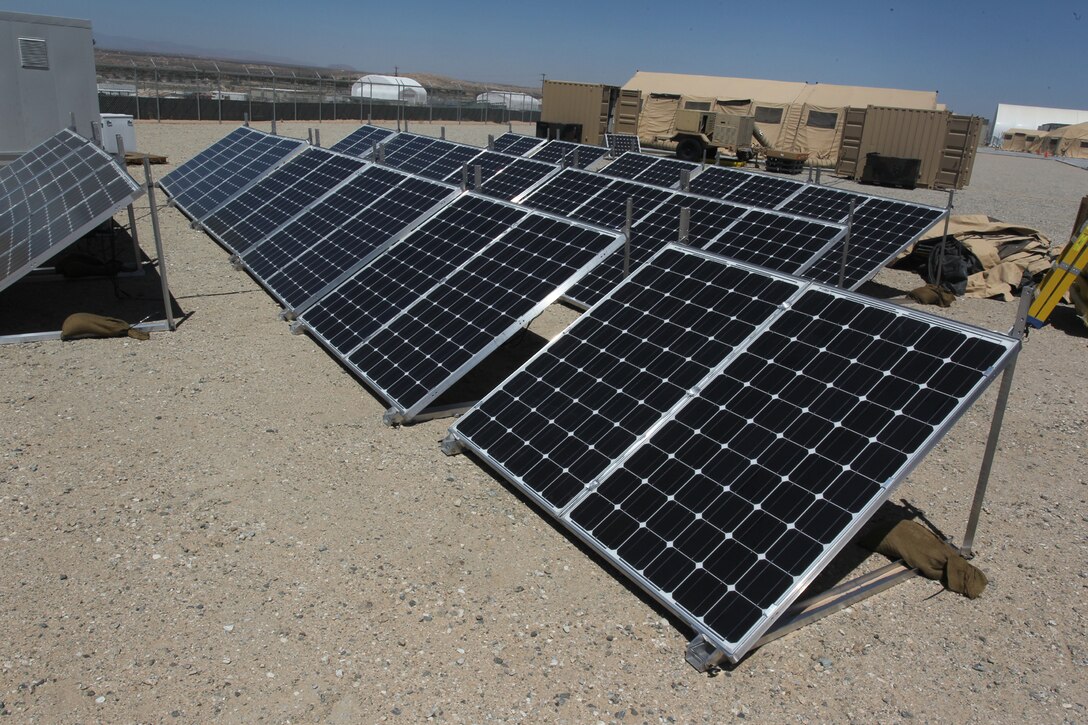 Solar panels soak up the desert sun outside of the generators and tents they are helping provide power for outside the Marine Corps Training Operations Group headquarters at the Marine Corps Air Ground Combat Center Twentynine Palms, Calif. The Corps is testing several “green initiative” systems designed to boost generator power, cutting fuel costs and prolonging the generators’ life spans. (Official USMC photo by Sgt. Heather Golden)