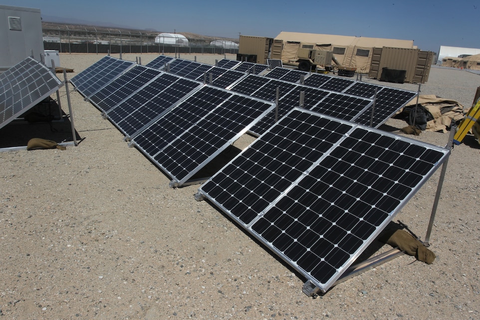 Solar panels soak up the desert sun outside of the generators and tents they are helping provide power for outside the Marine Corps Training Operations Group headquarters at the Marine Corps Air Ground Combat Center Twentynine Palms, Calif. The Corps is testing several “green initiative” systems designed to boost generator power, cutting fuel costs and prolonging the generators’ life spans. (Official USMC photo by Sgt. Heather Golden)
