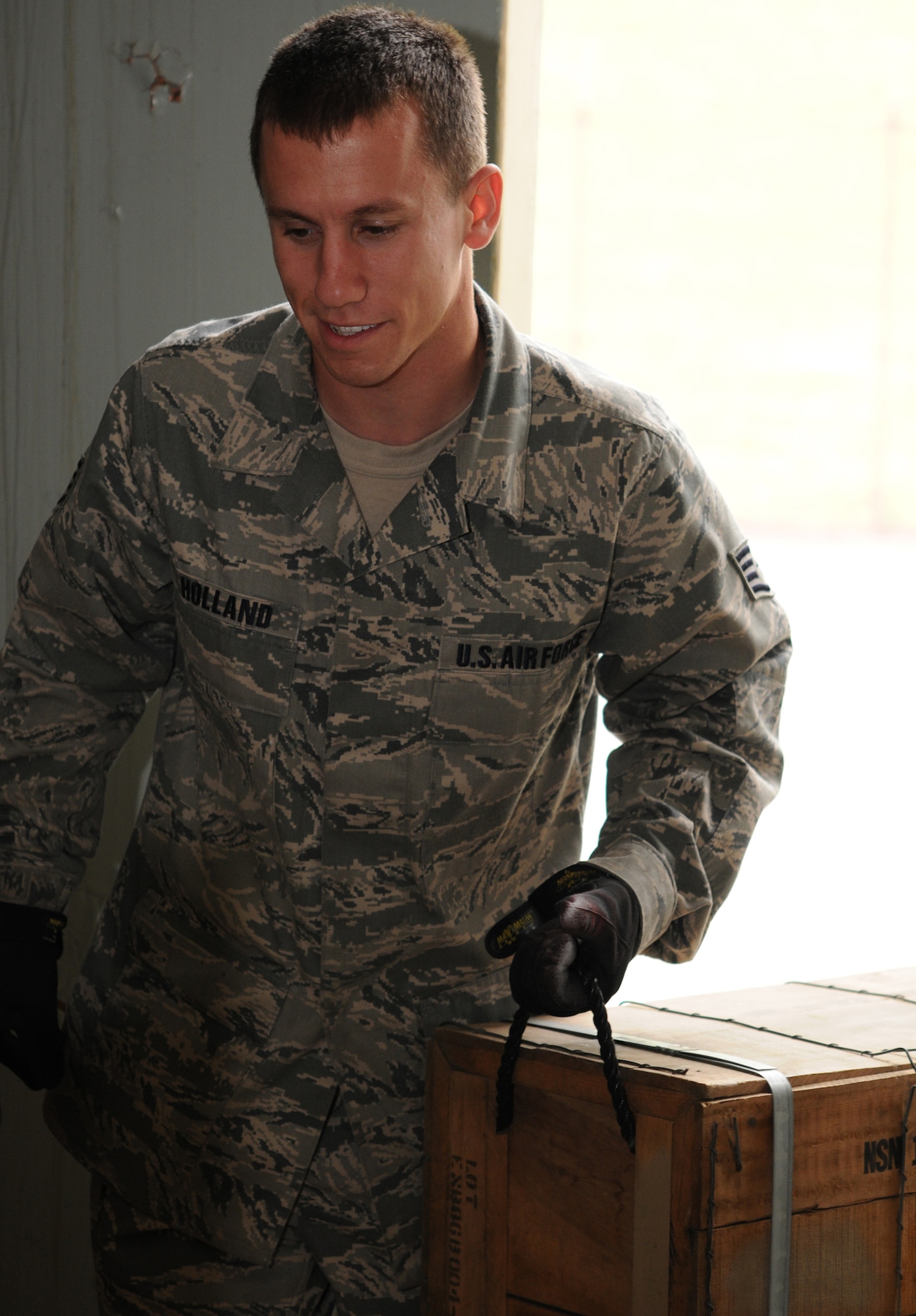 YOKOTA AIR BASE, Japan -- Staff Sgt. Jeffrey Holland, 374th Maintenance Squadron Munitions Flight stockpile surveillance crew chief, stores K-9 training kits May 26, 2011, at Yokota Air Base. The kits are used to train 374th Security Force Squadron's K-9 units.