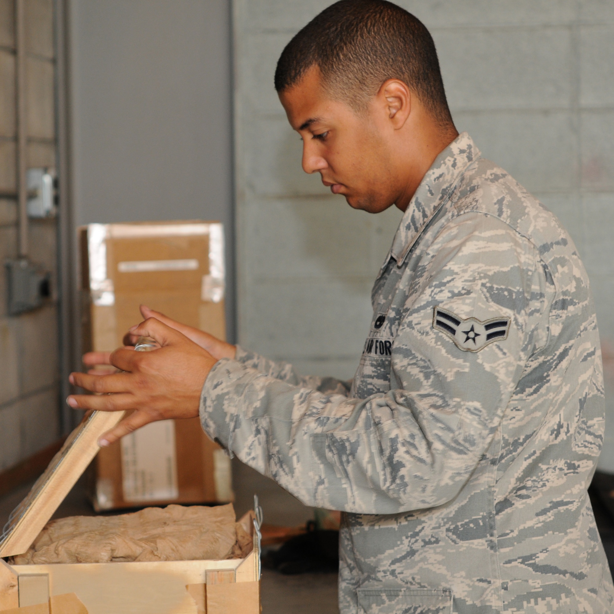 YOKOTA AIR BASE, Japan -- Airman 1st Class Joshua Butler, 374th Maintenance Squadron Munitions Flight stockpile surveillance crew member, packs unserviceable equipment May 26, 2011, at Yokota Air Base. The Munitions Flight maintains equipment to continuously improve the contingency capabilities of the 374th Airlift Wing and tenant units.  