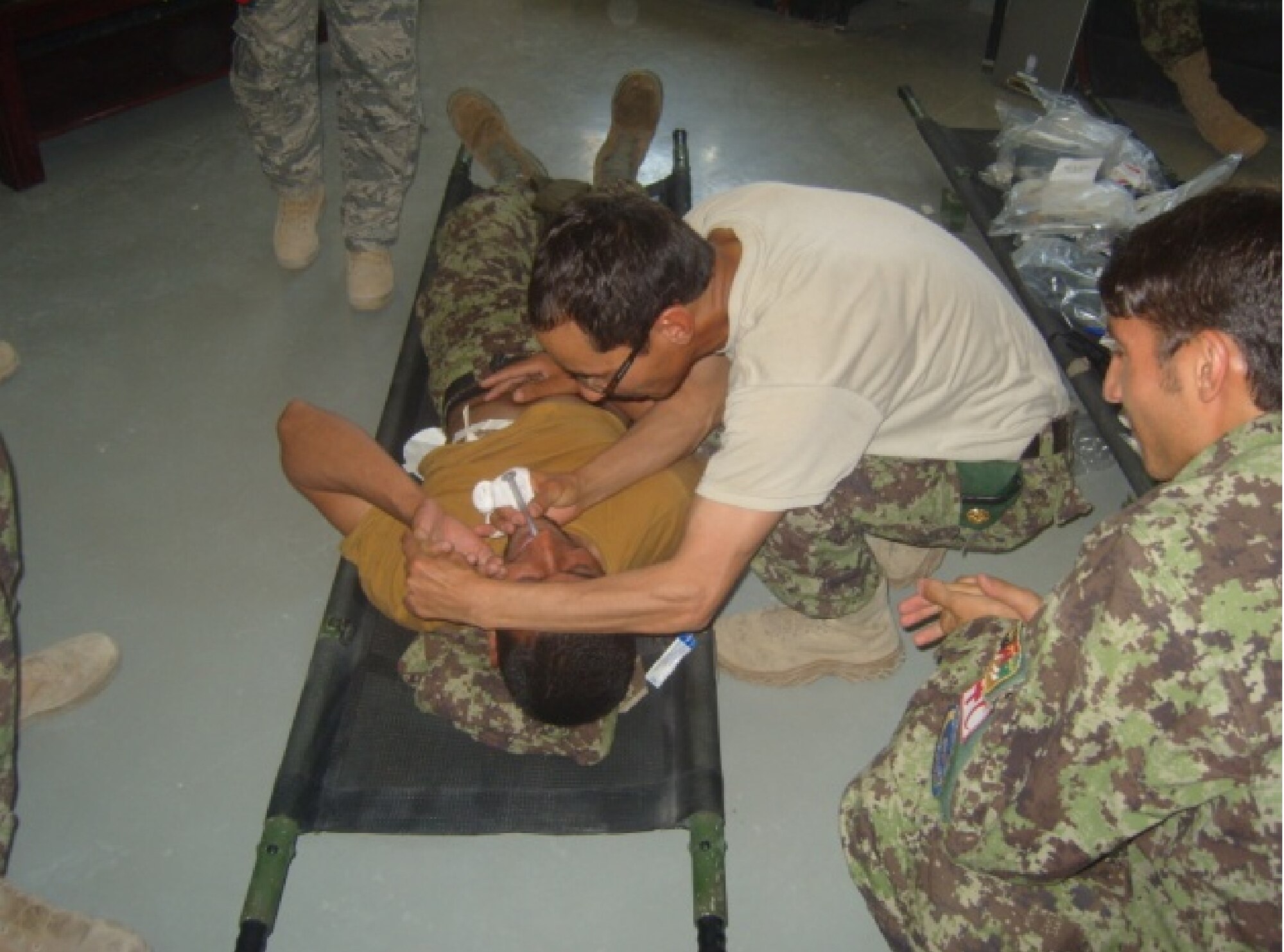 Afghan air force firefighter Hamidullah receives a nasopharyngeal from a Kandahar Air Wing Afghan air force medic during a combat life saver course May 22 at the KAW Fire Department. (U.S. Air Force courtesy photo)