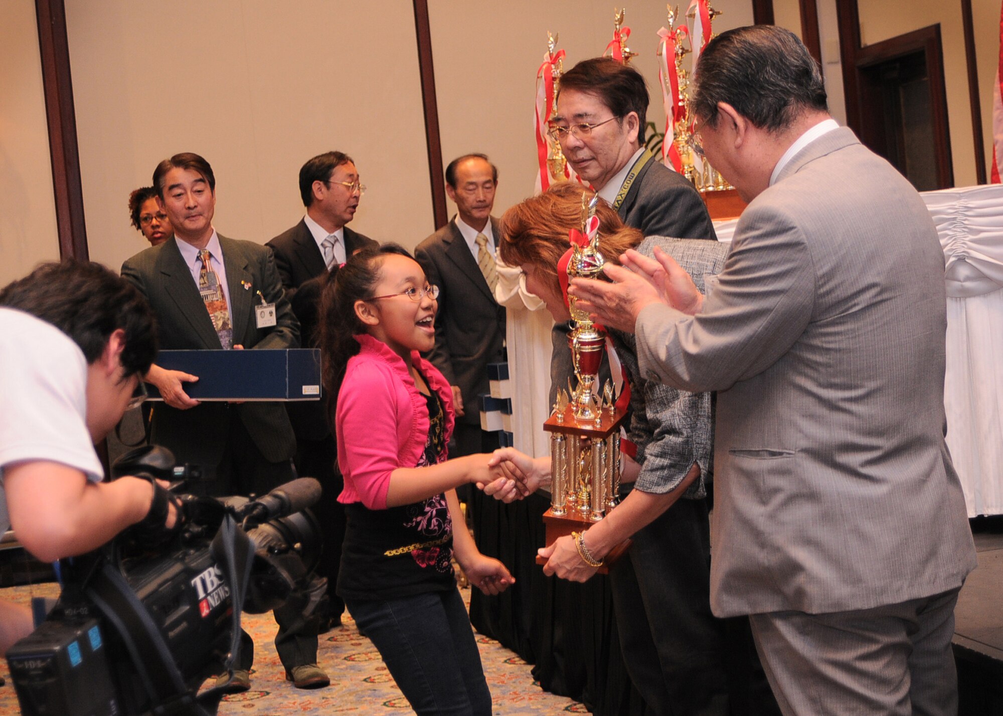 ROPPONGI, Japan -- Kanoka Palmer, from Yokota West Elementary School, accepts her trophy for winning first place in the written question category (grades 2-4) during the 29th Kanto Area Department of Defense Dependent Students soroban contest held at the New Sanno hotel, May 25, 2011, Roppongi, Japan. This year, Yokota won four prizes including first, second and third places in the written question category, and third place in the oral dictation category. (U.S. Air Force photo/Senior Airman Andrea Salazar)