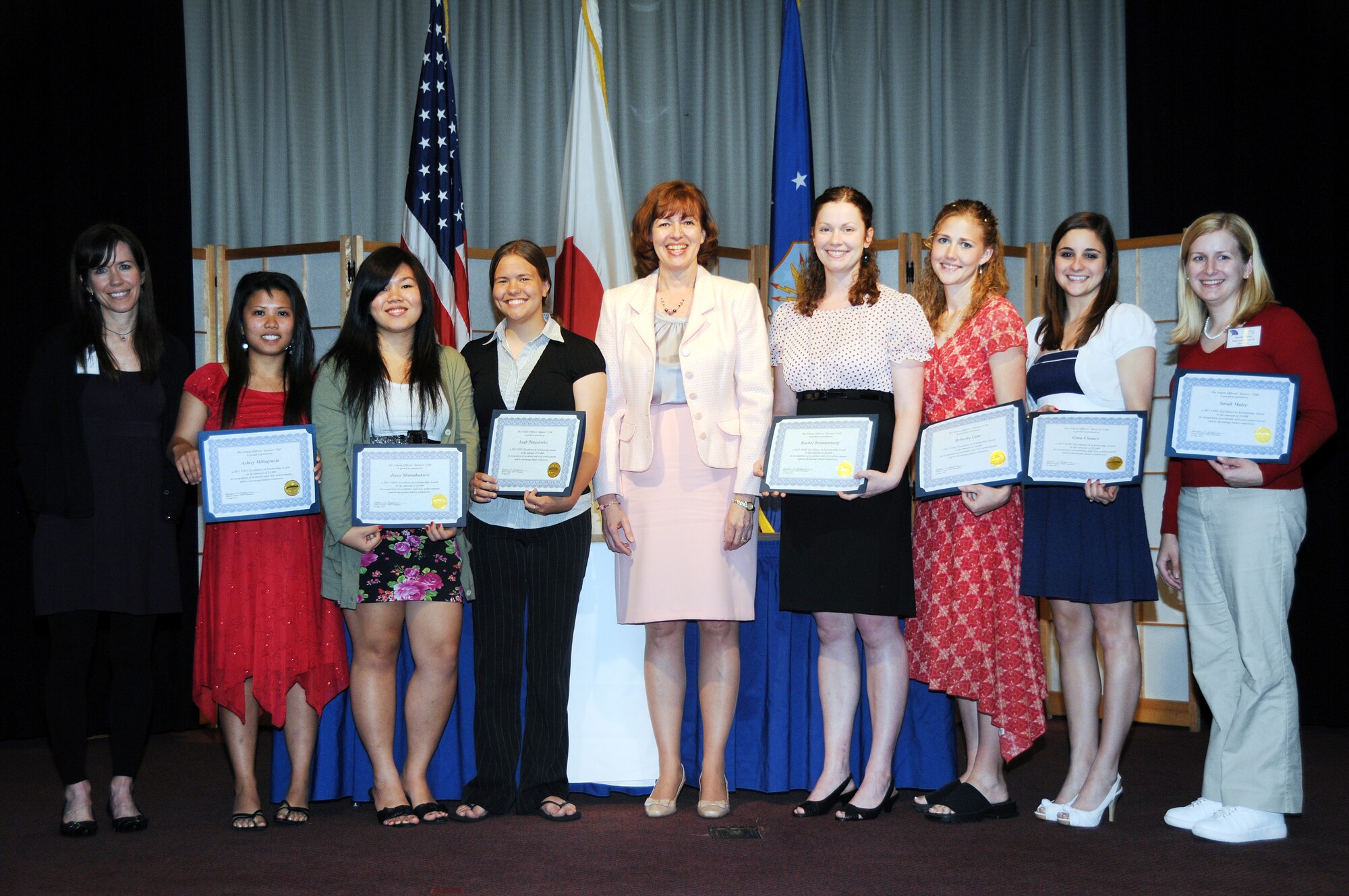 YOKOTA AIR BASE, Japan -- Yokota Officers' Spouses' Club presenters pose with scholarship recipients during an award presentation at Yokota Air Base, Japan, May 24, 2011. Pictured from left to right:  Shannon Martinez , Ashley Millagracia, Joyve Shimabukuro, Leah Panaziwicz, Nancy Feather, Rachel Brandenburg, Rebecka Lane, Gina Chance and Sarah Maley. (U.S. Air Force Photo/Airman 1st Class Katrina R. Menchaca)
