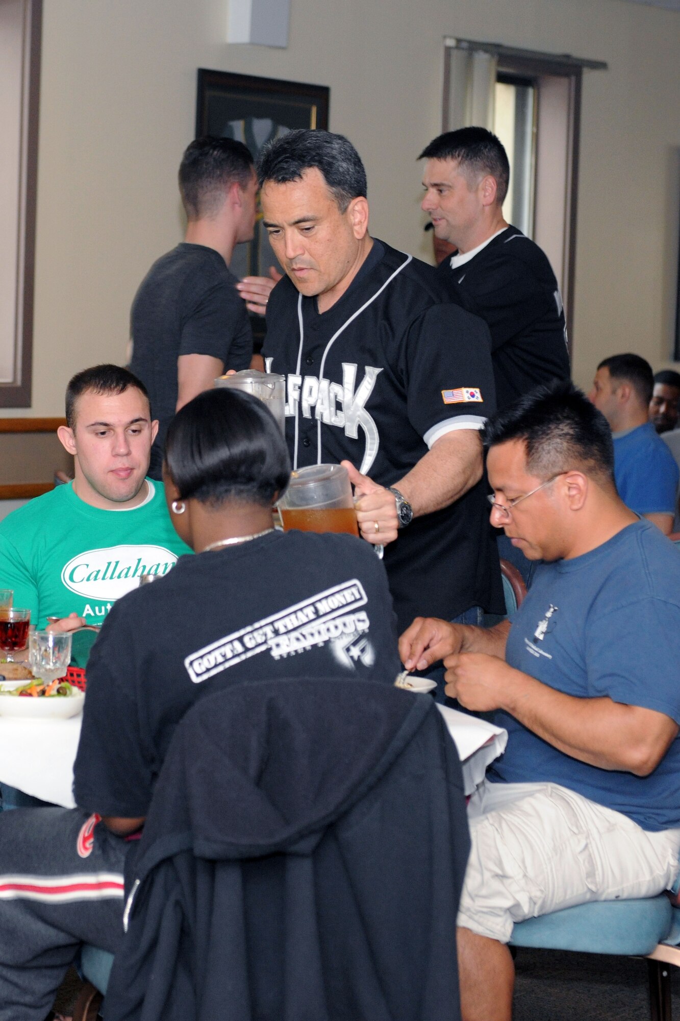 KUNSAN AIR BASE, Republic of Korea – Col. Hugh Hanlon, 8th Fighter Wing vice commander, serve Airmen drinks during the birthday meal at the dining facility here May 24. During dinner, females received roses and the oldest and youngest Airman got to cut the cake. (U.S. Air Force photo/Senior Airman Brittany Y. Bateman)
