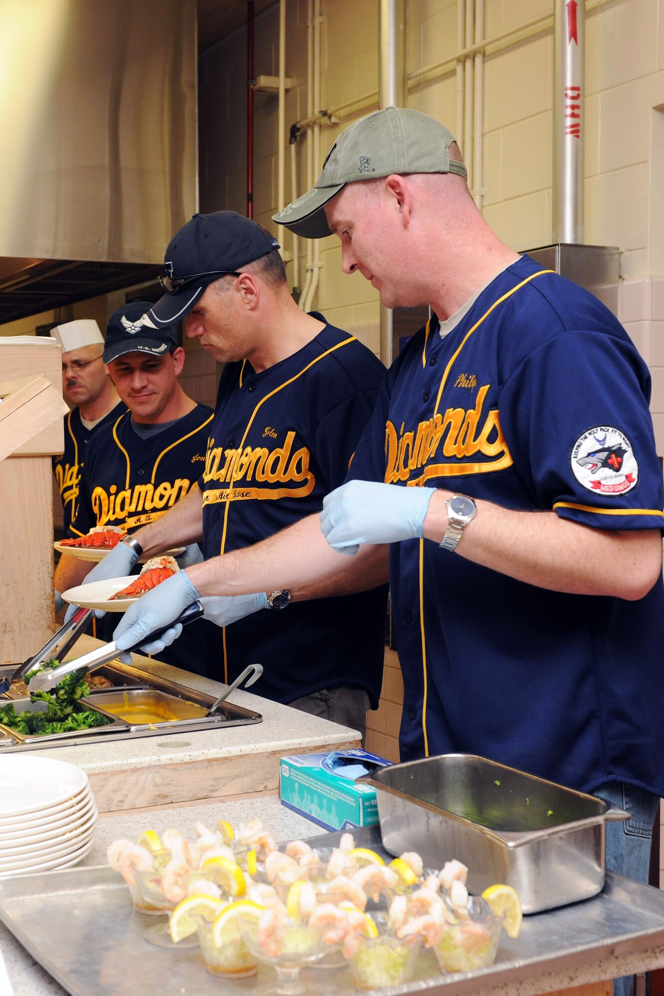 KUNSAN AIR BASE, Republic of Korea -- First sergeants serve dinner at the dining facility for the birthday meal here May 24. Wing leadership catered to Airmen during the dinner by serving Airmen their food, drinks and taking their plates when they were finished eating.  (U.S. Air Force photo/Senior Airman Brittany Y. Bateman)
