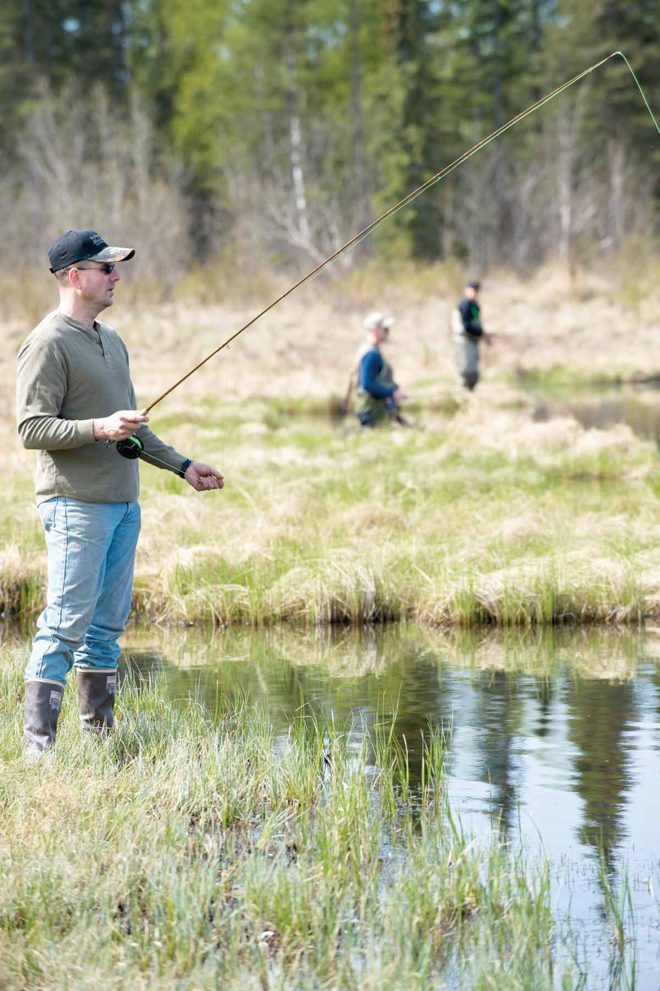 Army Capt. James Williamson of the 3rd Maneuver Enhancement Brigade fishes at Green Lake. Wiliamson volunteers his time regularly with the program, teaching fly-tying and fishing. (U.S. Air Force photo/Johnathon Green)