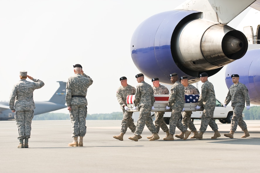 A U.S. Army carry team transfers the remains of Army Pfc. William S. Blevins, of Sardinia, Ohio, at Dover Air Force Base, Del., May 25, 2011. Blevins was assigned to the 2nd Battalion, 27th Infantry Regiment, 3rd Brigade Combat Team, 25th Infantry Division, Schofield Barracks, Hawaii. (U.S. Air Force photo/Roland Balik)