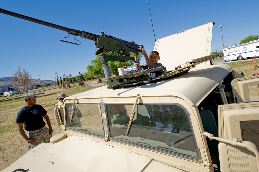 ALAMOGORDO, N.M. -- Nine-year-old Ramiro Saenz sits in the turret of an 1165 High Mobility Multipurpose Wheeled Vehicle displayed by the N.M. Army National Guard, Delta Company, during Armed Forces Day, May 21, 2011, at Washington Park. Infantry soldiers allowed people to climb inside of a HMMWV to get a feel for what military members drive while deployed. (U.S. Air Force photo by Senior Airman Veronica Stamps/Released)