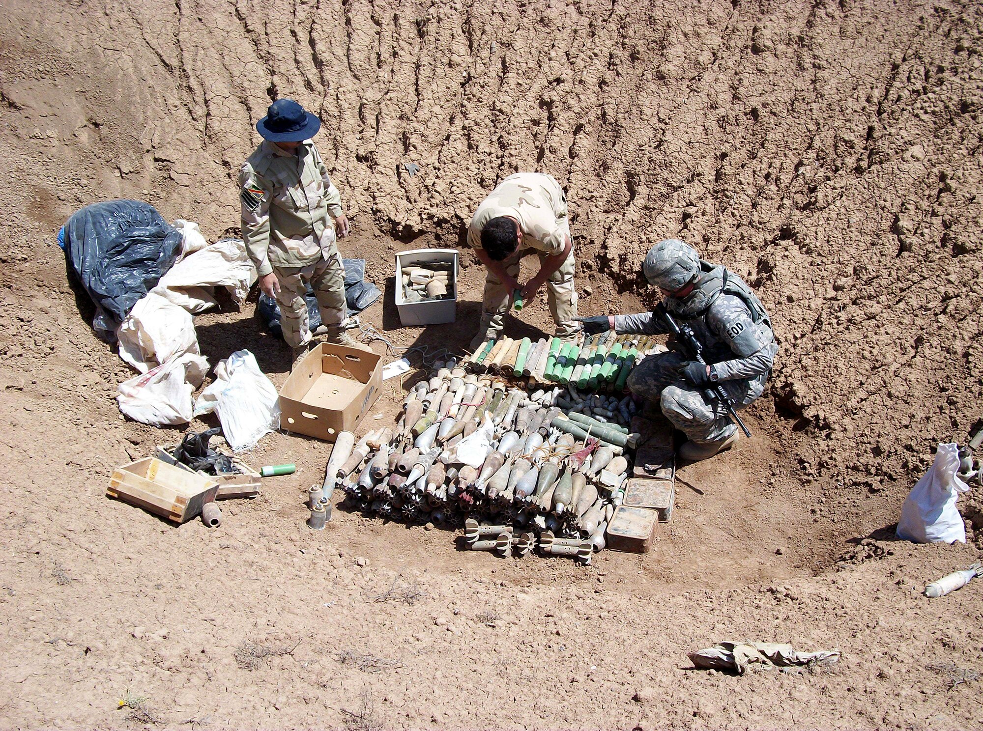 Iraqi airmen pass down munitions and unexploded ordnances for a detonation April 28, 2011, Contingency Operating Site Warrior in Iraq.(Courtesy photo) 
