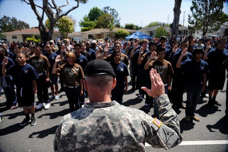 TORRANCE, Calif. -- Army Gen. Robert Cone, the Army Training and Doctrine Command commander, swears in men and women from all the branches of the military during Armed Forces Day Saturday, May 21, 2011.  The future military members marched in the 52nd Annual Armed Forces Day parade which ended with an enlistment ceremony.  (U.S. Air Force photo/Staff Sgt. Andrew Satran) 

  
 