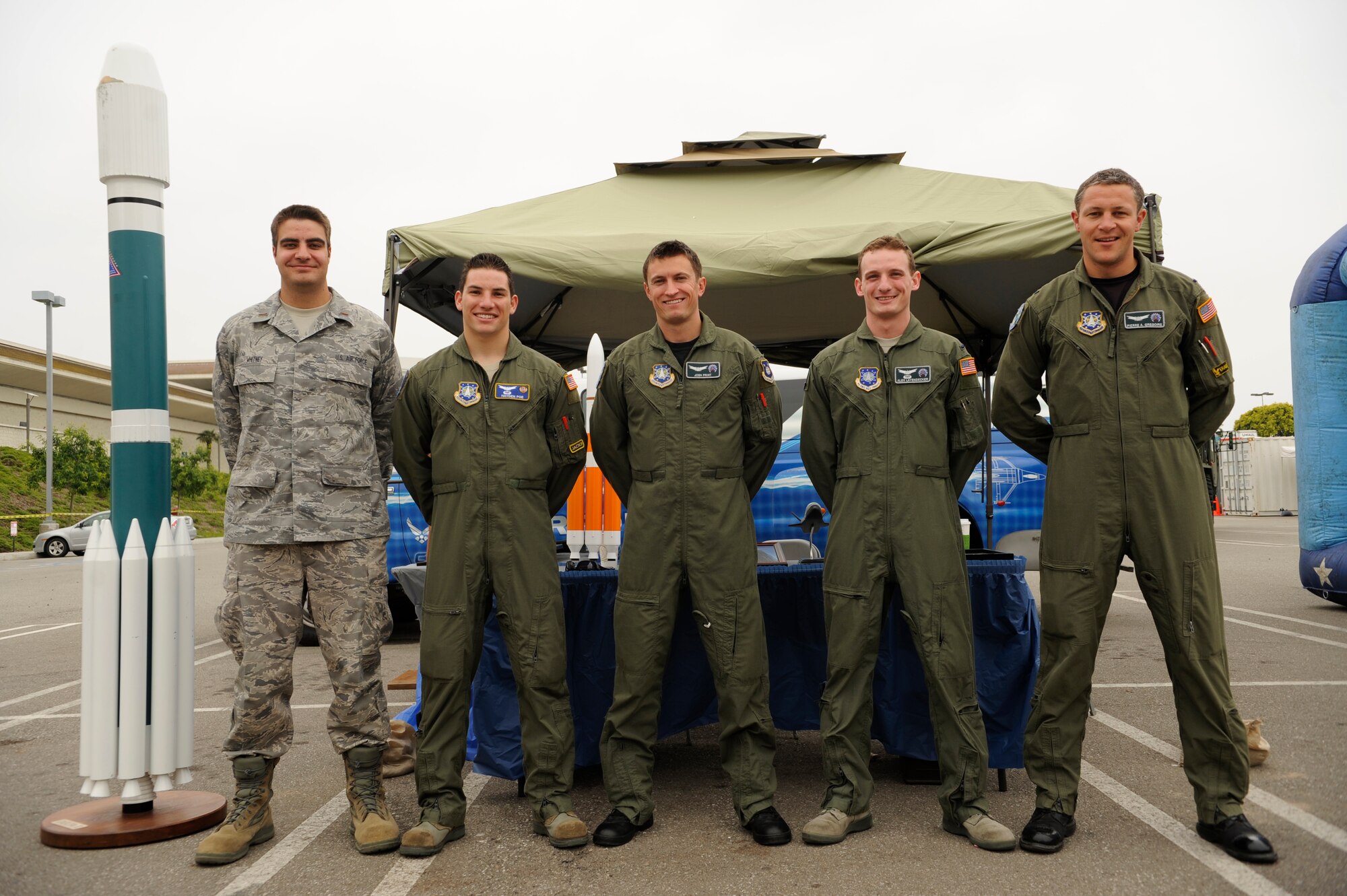 TORRANCE, Calif. -- Members from Vandenberg pose for a photo in front of their display during Armed Forces Day at the Del Amo center here Saturday, May 21, 2011.  The display showcased different missions performed at Vandenberg.  (U.S. Air Force photo/Staff Sgt. Andrew Satran) 

 
 