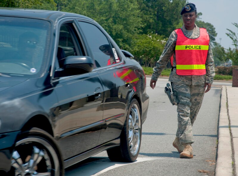 Staff Sgt. Mekesha Vinson, 23rd Security Forces Squadron, walks to a car during a safety enforcement scenario May 24. During the scenario, Sergeant Vinson demonstrated how to deal with a driver who was seen using a cell phone. (U.S. Air Force photo/Airman 1st Class Paul Francis)(RELEASED)