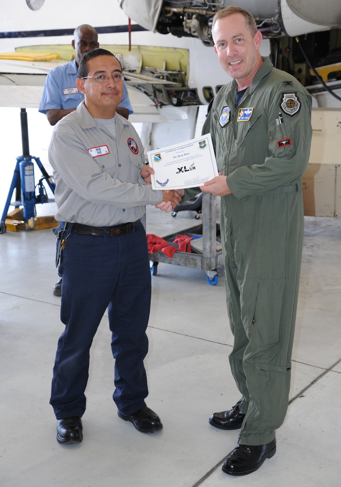 LAUGHLIN AIR FORCE BASE, Texas – Rene Ruiz, 47th Maintenance Directorate, is presented the XLer of the Week award by Col. Michael Frankel, 47th Flying Training Wing commander, here May 18. The XLer is a weekly award chosen by wing leadership and given to those who consistently make outstanding contributions to Laughlin and their unit. (U.S. Air Force photo by Airman 1st Class Blake Mize)