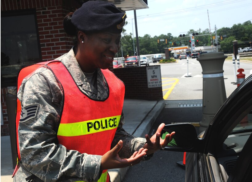 Staff Sgt. Mekesha Vinson, 23rd Security Forces Squadron, speaks with a driver during a safety enforcement scenario May 24. The scenario was in part of the Click-It or Ticket campaign which is designed to help reduce highway fatalities and reinforce Moody’s commitment to safety. (U.S. Air Force photo/Airman 1st Class Paul Francis)(RELEASED)