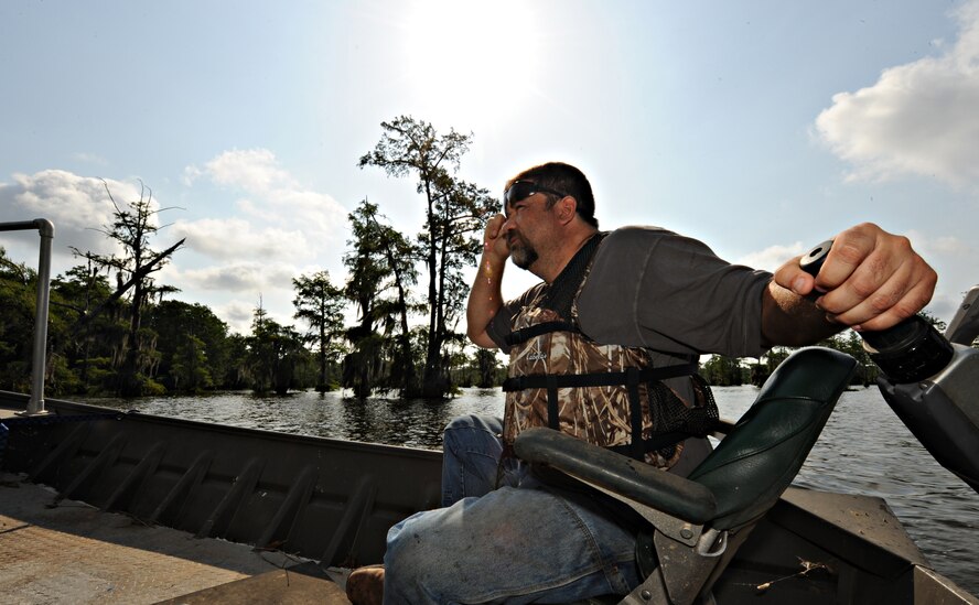Mark Gates, 2nd Civil Engineer Squadron, searches for wildlife on Flag Lake on Barksdale Air Force Base, La., May 24. The Natural Resources office is in charge of animal control including the distribution of hunting and fishing licenses during hunting seasons.(U.S. Air Force photo/Senior Airman Kristin High)(RELEASED) 