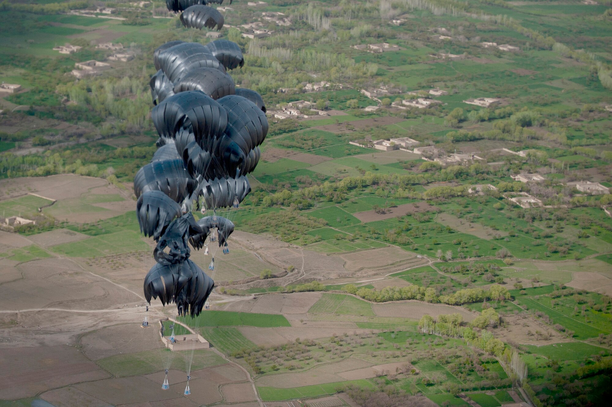 Aerial delivery cargo drops April 15, 2011, above Afghanistan. (U.S. Air Force photo/Master Sgt. Adrian Cadiz)