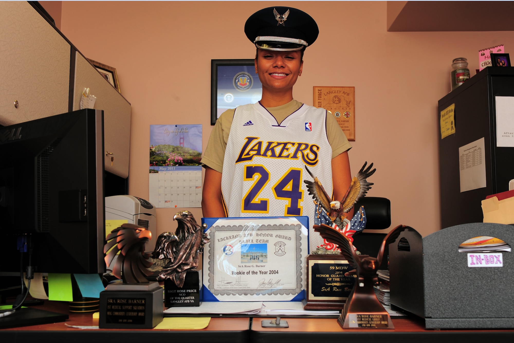 SHAW AIR FORCE BASE, S.C. -- Staff Sgt. Rose Price, 20th Medical Support Squadron NCOIC resource manager, shows some of her various awards along with her Honor Guard cap and Lakers jersey to demonstrate her diversity May 25, 2011. Sergeant Price is the Warrior of the Week for May 23 through 27, 2011. She is the lead physical training leader for her squadron, and has demonstrated great professionalism and leadership.(U.S. Air Force photo/Airman 1st Class Daniel Phelps)