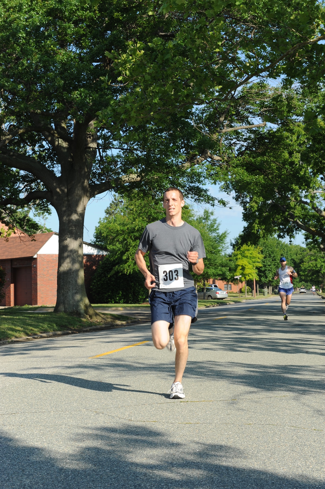 Senior Airman Joel Bertrand, 633d Logistics Readiness Squadron supply manager, sprints to the finish line at the Langley First Sergeant’s Operation Warm Heart 5k Walk/Run at Langley Air Force Base, Va., May 20, 2011. More than $2,600 in proceeds   were donated to Operation Warm Heart, a year-round program designed to assist Airmen and their families. (U.S. Air Force photo by Senior Airman Antoinette Gibson) (RELEASED)