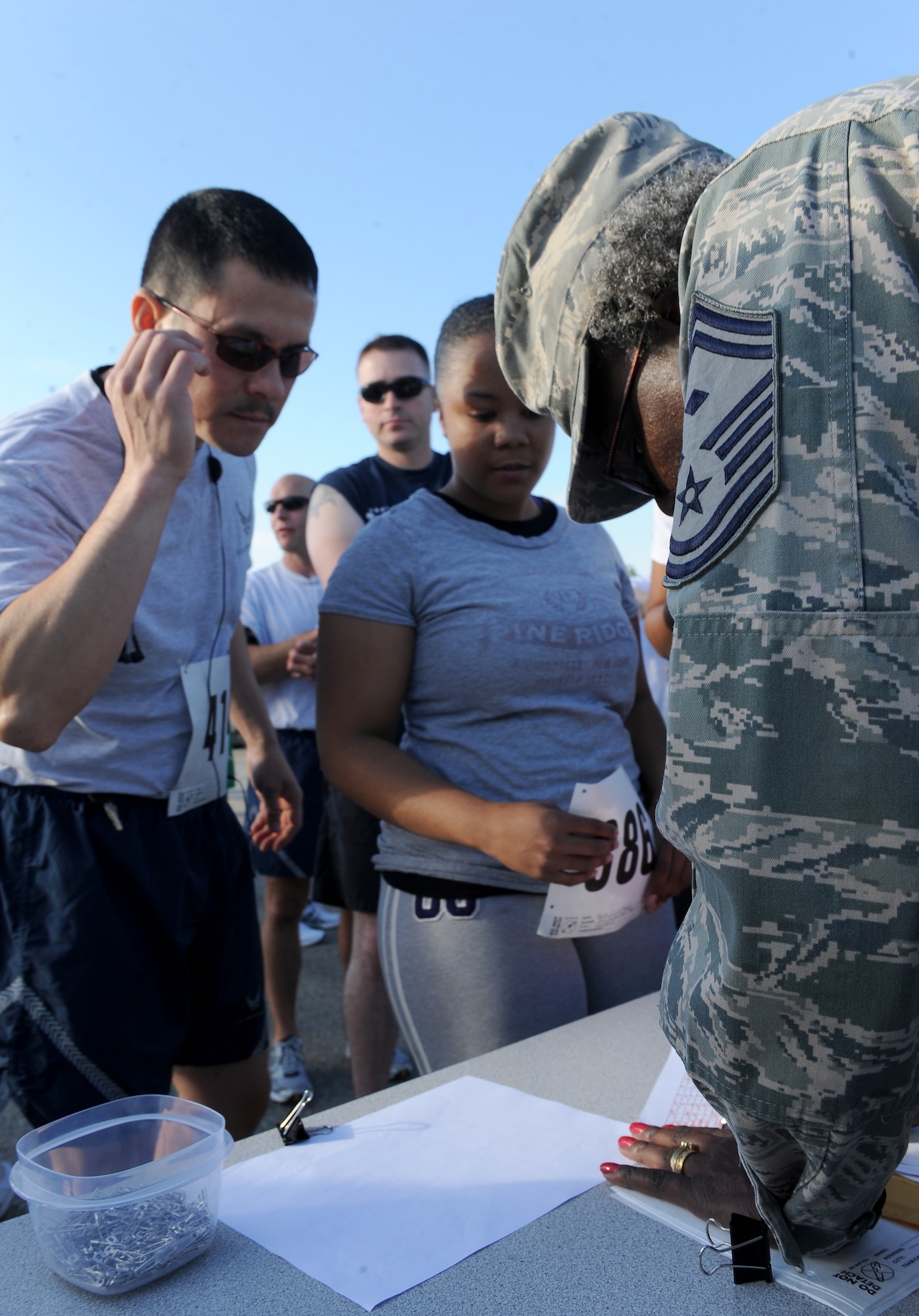 Airmen  register at the Langley First Sergeant’s Operation Warm Heart 5k Walk/Run at Langley Air Force Base, Va., May 20, 2011.  More than $2,600 in proceeds  were donated to Operation Warm Heart, a year-round program designed to assist Airmen and their families. (U.S. Air Force photo by Senior Airman Antoinette Gibson) (RELEASED)