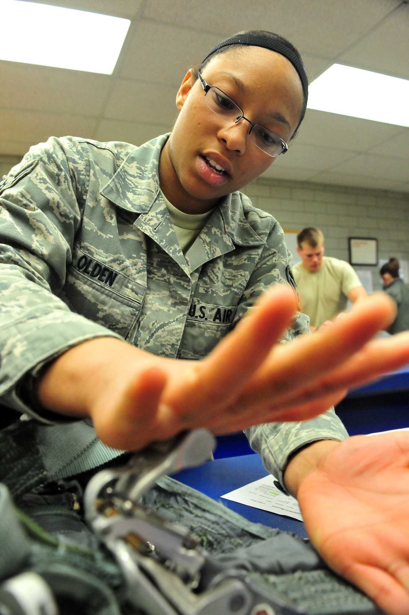 MINOT AIR FORCE BASE -- Airman 1st Class Tyandra Olden, 5th Operations Support Squadron aircrew flight equipment technician, helps refurbish parachute survival kits at the AFE parachute shop here May 16. Aircrew flight equipment members inspect and maintain life-saving appliances and gear for the B-52H Stratofortress, as well as all 5th Bomb Wing aircrew personnel. (U.S. Air Force Photo/Senior Airman Jesse Lopez) 
