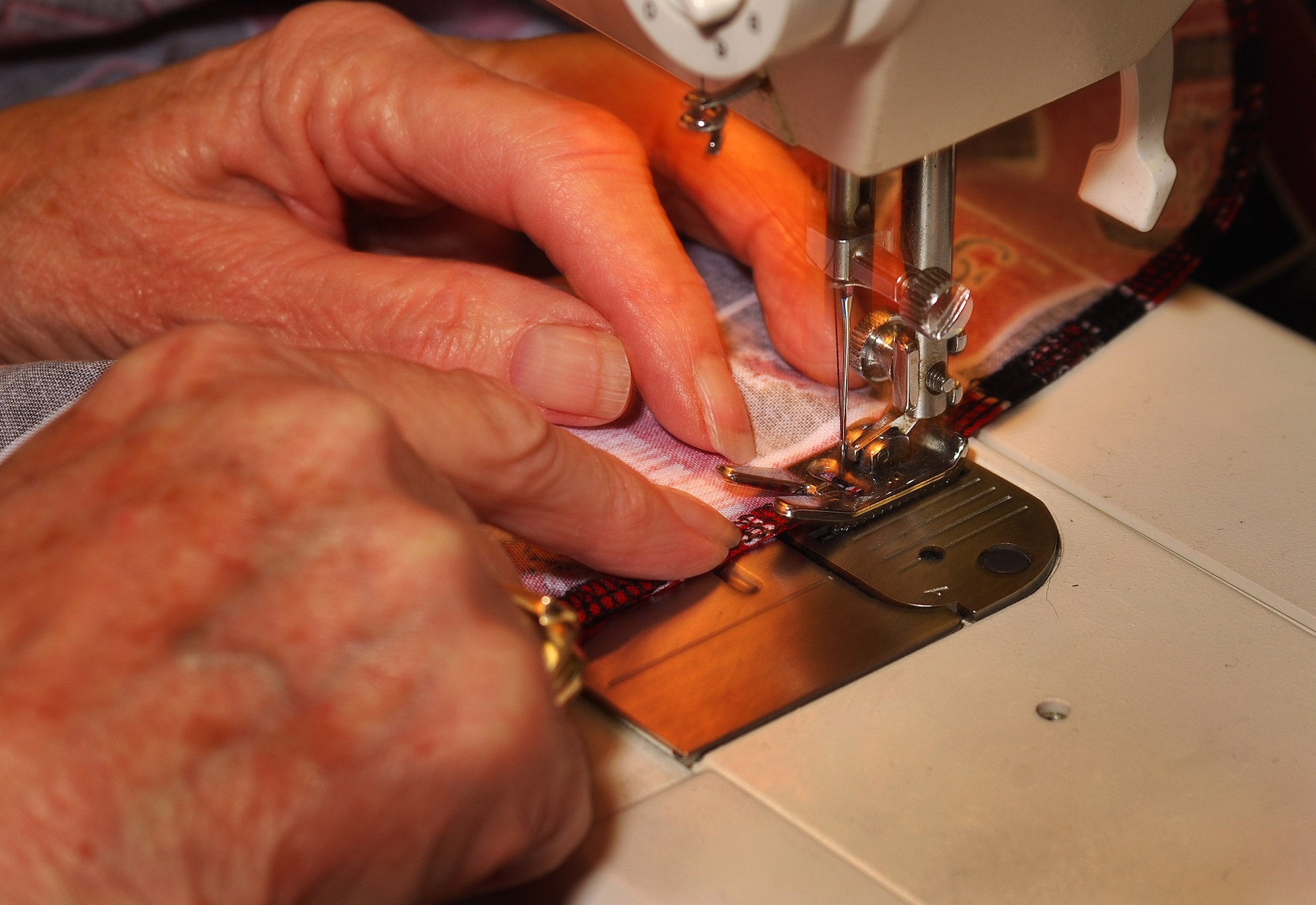 Thelma Jenkins sews a pair of pants destined for a wounded warrior in need of specialty clothing due to their injuries.  She volunteers with a local group of women to provide adaptive clothing for wounded warriors through the Sew Much Comfort volunteer charity organization.  Sew Much Comfort is a recognized charity, #12289 under the Combined Federal Campaign and they need your donations.    (U.S. Air Force photo/ Brad Fallin)