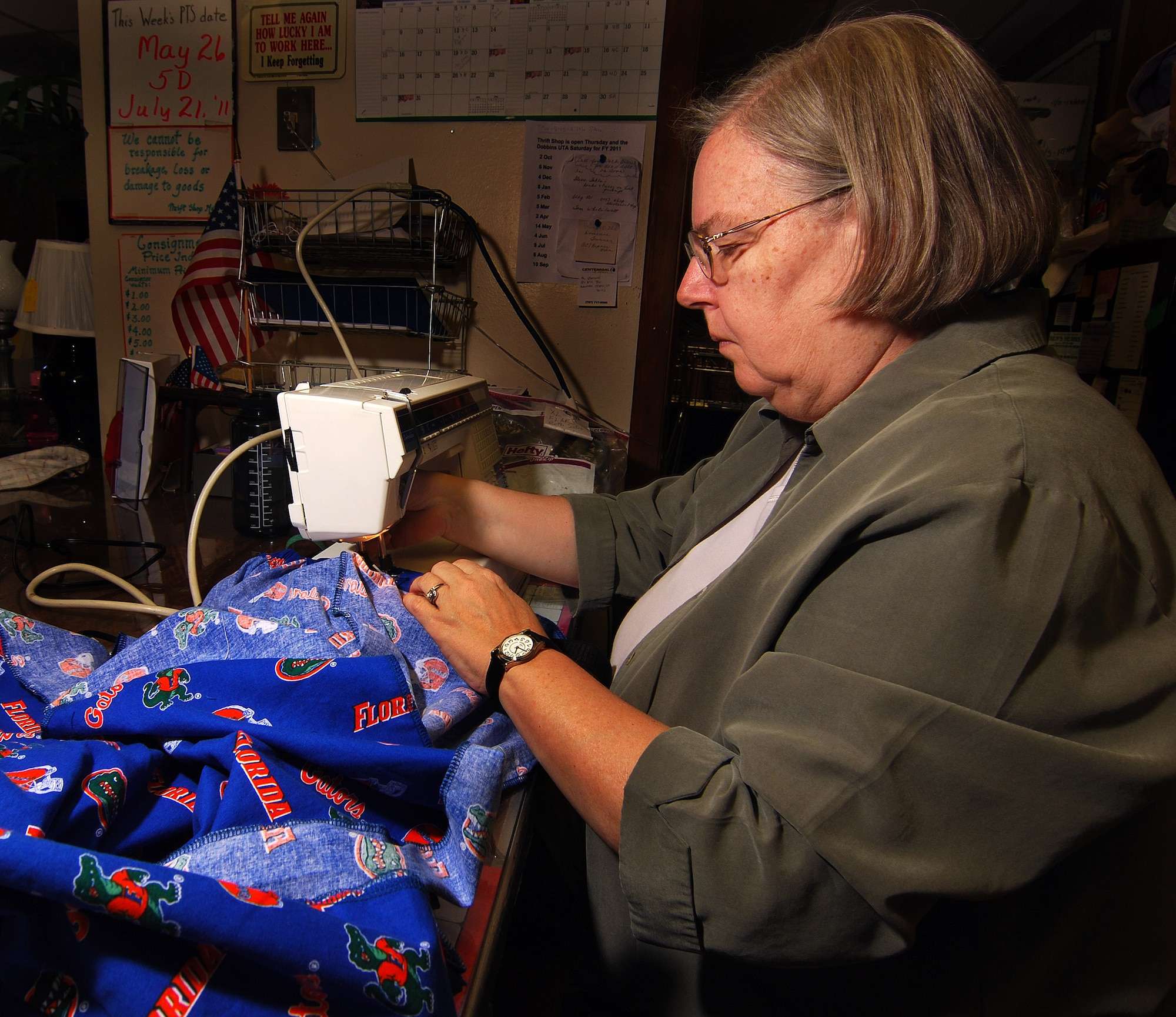 Anne Groskreutz sews a pair of pants destined for a wounded warrior in need of specialty clothing due to their injuries.  She volunteers with a local group of women to provide adaptive clothing for wounded warriors through the Sew Much Comfort volunteer charity organization.  Sew Much Comfort is a recognized charity, #12289 under the Combined Federal Campaign and they need your donations.    (U.S. Air Force photo/ Brad Fallin)