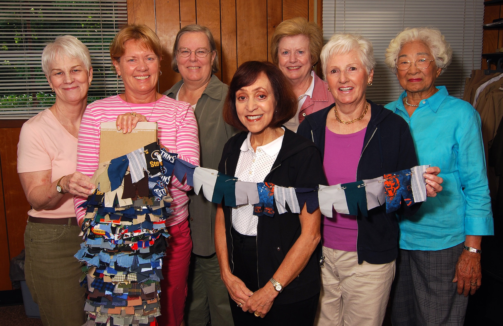 HotLanta Hot Pants group members from left to right are Kathleen Sisk, Luanne Torblaa, Anne Groskreutz, Adele Syracuse, Dorothy Bankers, Thelma Jenkins and Yuki Hill.  They are displaying miniature samples of the more than 800 pair of pants they have made since forming the group in 2004.  Their sewing group is part of a national effort under the main organization called Sew Much Comfort.   (U.S. Air Force photo/ Brad Fallin)