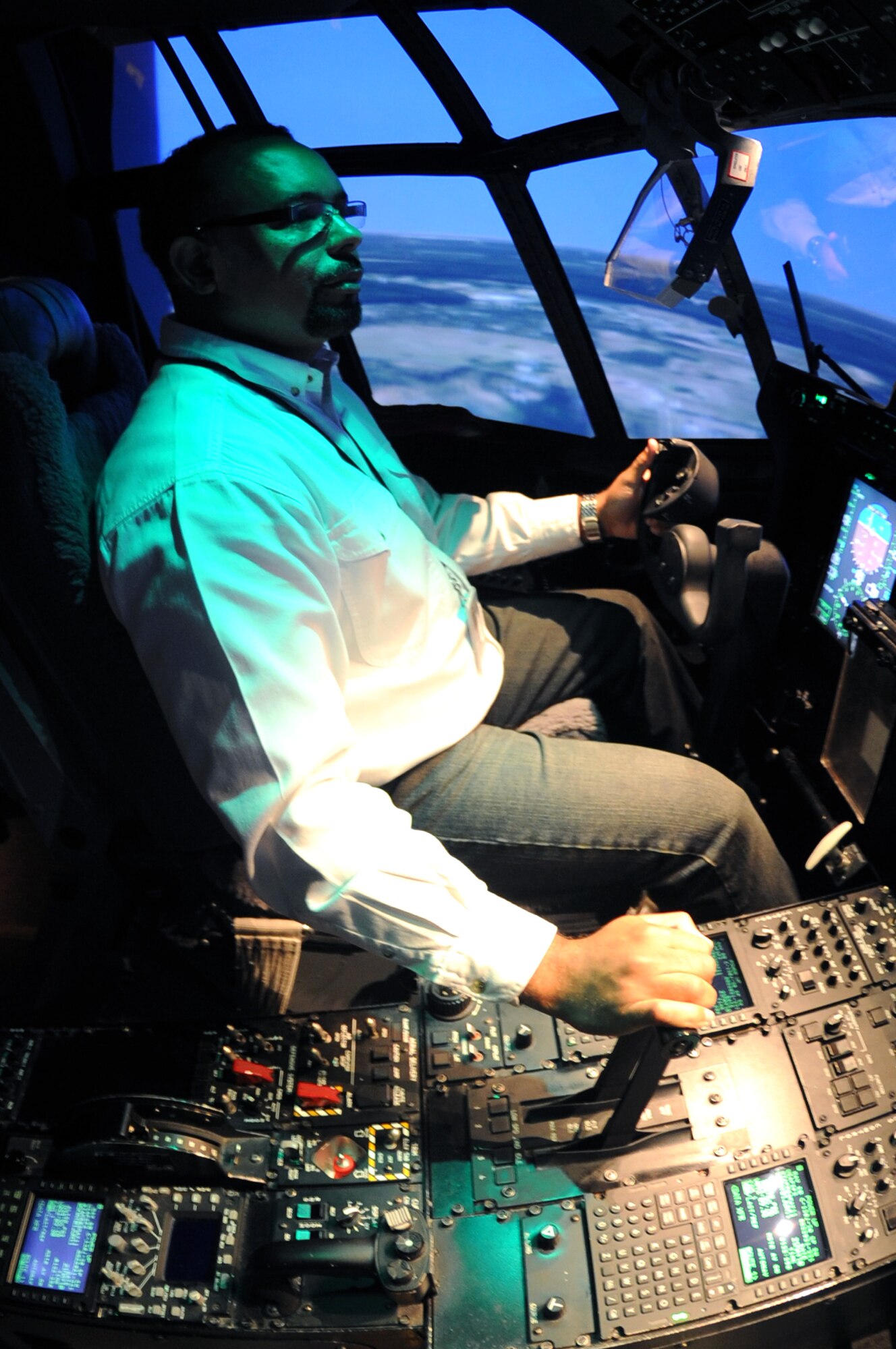Darrell Penn, a Detachment 3 Air Mobility Command Air Operations Squadron C-130 equipment specialist, performs a visual check in the C-130J model flight simulator May 24, 2011, at Little Rock Air Force Base, Ark.  The Winston-Salem, N.C., native led seven C-130, Avionics Modernization Program, and J simulator and training device certifications, identifying 48 discrepancies. (U.S. Air Force photo/Airman 1st Class Rusty Frank)