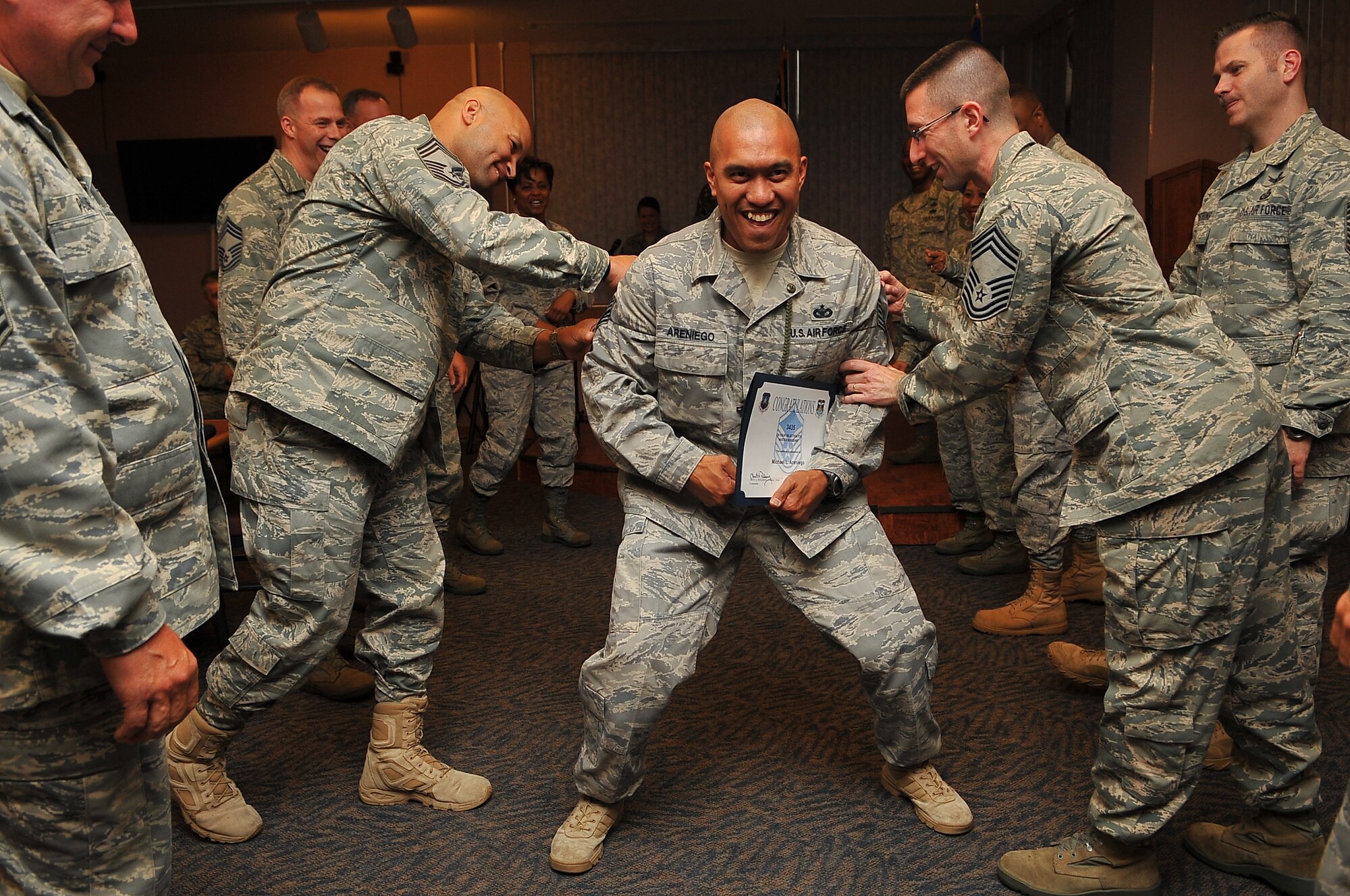 BUCKLEY AIR FORCE BASE, Colo. -- Buckley AFB Chief Master Sgts. congratulate Tech. Sgt. Michael Areniego, 460th Security Forces Squadron, on his selection for the rank of Master Sgt. Team Buckley had 32 selectees, to include those from its tenant units, this year. (U.S. Air Force photo by Staff Sgt. Kathrine McDowell)