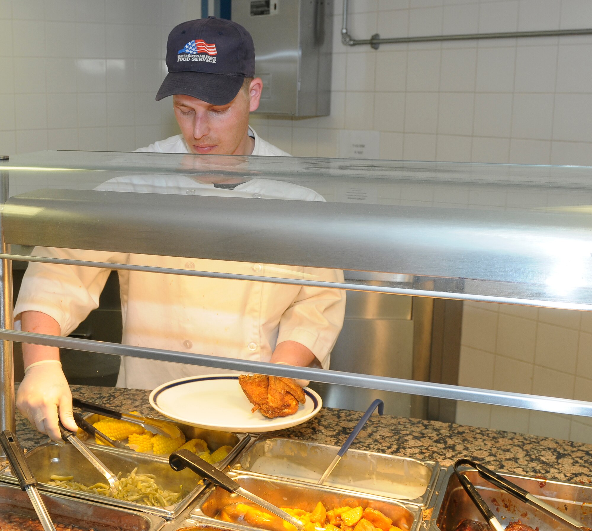 ROYAL AIR FORCE LAKENHEATH, England -- Danny Maynard, 48th Force Support Squadron contractor supervisor, prepares a plate of food at the Knight's Table Dining Facility May 20, 2011.  The DFAC will close from June 17 to Sept. 8 for renovations and will receive $850,000 worth of upgrades including improvements to the dining rooms, bathrooms, kitchen and front office areas.  (U.S. Air Force photo/Staff Sgt. Connor Estes)