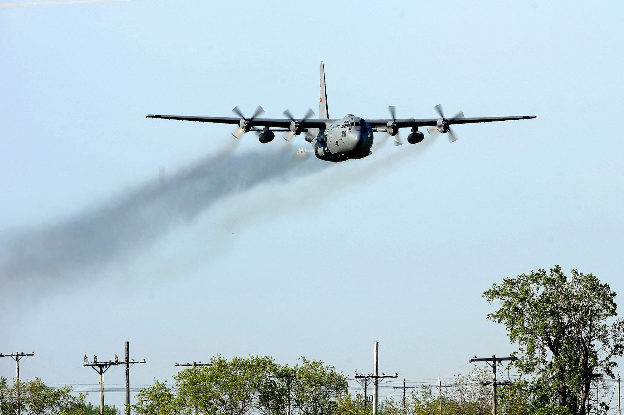 An Air Force Reserve aircrew flying a C-130 Hercules assigned to the 910th Airlift Wing, Youngstown Air Reserve Station, Ohio, performs a mosquito control aerial spray mission over Grand Forks Air Force Base. The spray team, which uses a specially-modified C-130H aircraft and Modular Aerial Spray Systems, make low passes around the spray areas at an altitude of 100-150 feet. They disperse pesticides which target areas of standing water where mosquito larvae breed. The purpose of the mission is to lower the number of irritations and infections associated with mosquito bites, as well as minimize the threat of West Nile Virus.  This is the first scheduled spray of three here for 2011. (U.S. Air Force photo by Tech. Sgt. Johnny Saldivar)


