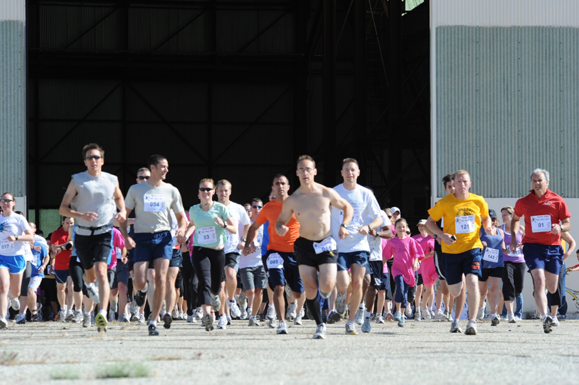 About 200 Team Edwards members launch out of an Air Force Research Laboratory Detachment 7 hangar May 20 for this year's annual Rat Race. The 5K fun run tested the runners' endurance and determination by having to climb Leuhman Ridge. Organizers say the race follows the highest and most daunting course on Edwards. (Air Force photo by Ron Fair)