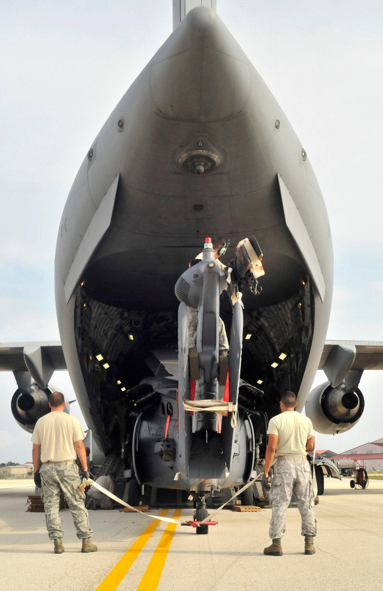 PATRICK AIR FORCE BASE, Fla.- Airmen from the 920th Rescue Wing Maintenance Group here help load a fixed-wing HH-60G Pave Hawk helicopter on a C-17 Globemaster III cargo aircraft. The C-17 is capable of rapid strategic delivery of troops and all types of cargo to main operating bases or directly to forward bases in the deployment area. (U.S. Air Force photo/Airman First Class Natasha Dowridge)