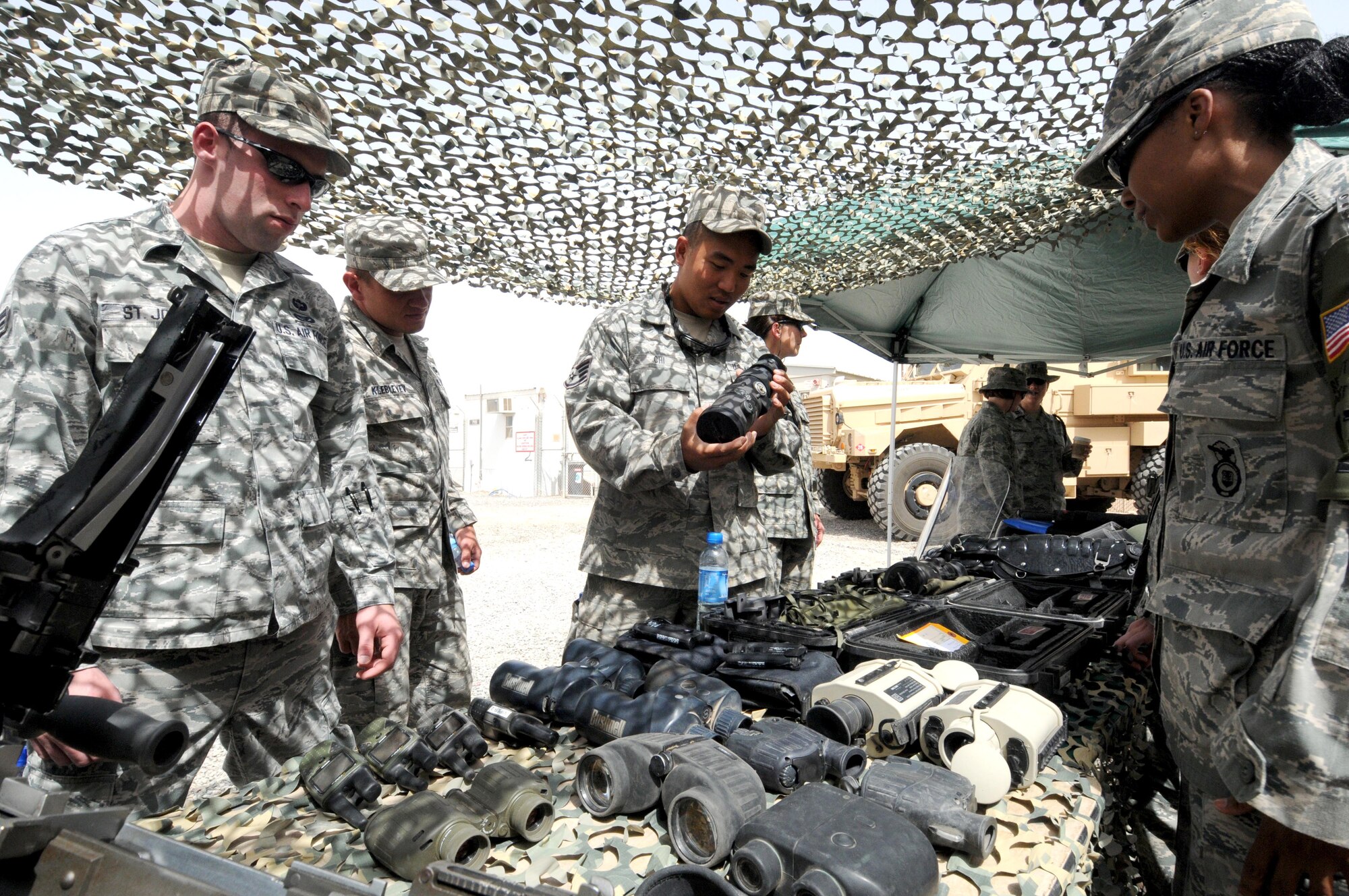 Members of the 386th Air Expeditionary Wing check out surveillance equipment on display by the 386th Expeditionary Security Forces Squadron May 11 at an undisclosed location in Southwest Asia. The 386th and 387th ESFS celebrated and honored Police Week with a multitude of events. (U.S. Air Force photo by Staff Sgt. Patrice Clarke)