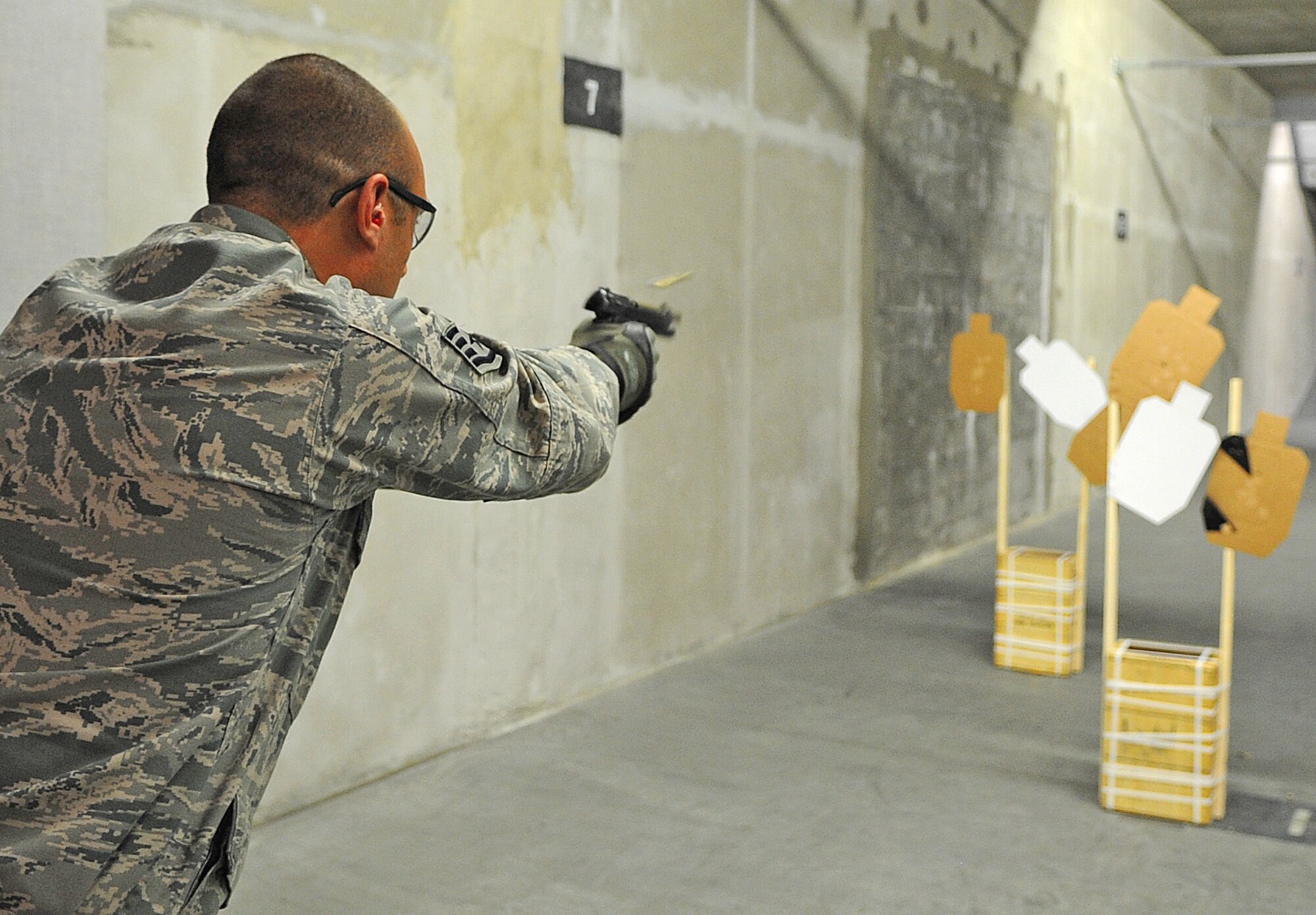SEYMOUR JOHNSON AIR FORCE BASE, N.C. -- Staff Sgt. Dino Legg, 4th Security Forces Squadron trainer, fires an M-9 Pistol during the National Police Week shoot-off competition here May 20, 2011. Tech. Sgt. David Bargor, 4th Security Forces Squadron, won first place at the competition, followed respectively by Officers Collins and Ravine of the Goldsboro Police Department. (U.S. Air Force photo/Senior Airman Gino Reyes)(Released)