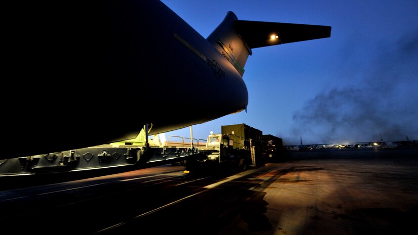 Cargo is loaded onto a C-17 Globemaster III assigned to the 385th Air Expeditionary Group at Kandahar Airfield, Afghanistan, for a flight to Mihail Kogalniceanu Air Base, Romania, May 20.  Several C-17s are temporarily deployed to MK from another base in the region that is closed for routine runway repairs.  (U.S. Air Force photo by Master Sgt. Laura K. Deckman/released)
