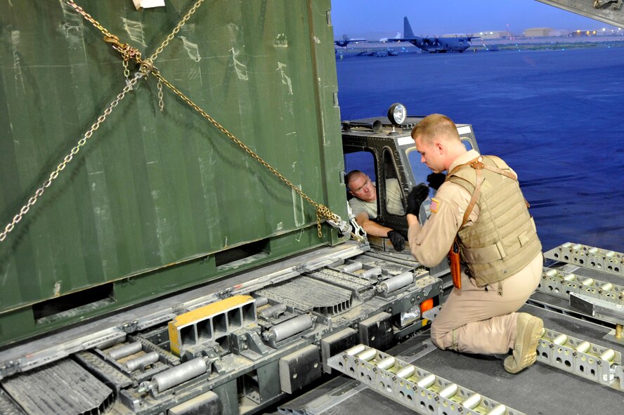 Senior Airman Neal Ylitalo, 17th Airlift Squadron loadmaster, loads cargo onto a C-17 Globemaster III at Kandahar Airfield, Afghanistan, for a flight to Mihail Kogalniceanu Air Base, Romania, on May 20, 2011. Several C-17s are temporarily deployed to MK from another base in the region that is closed for routine runway repairs. (U.S. Air Force Photo/Master Sgt. Laura K. Deckman)