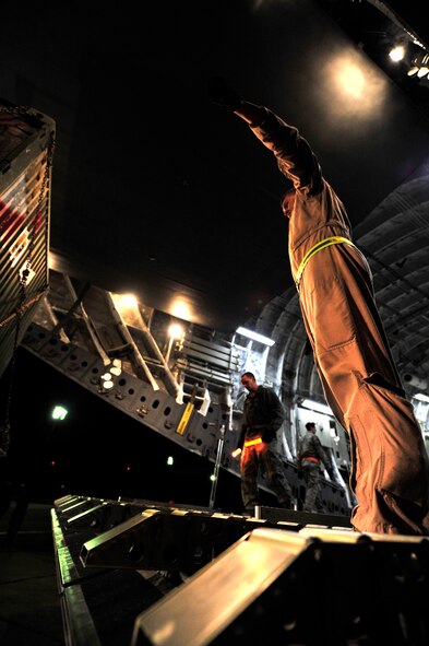 Senior Airman Neal Ylitalo, 17th Airlift Wing loadmaster, off-loads cargo from a C-17 Globemaster III after a flight from Kandahar Airfield, Afghanistan, to Mihail Kogalniceanu Air Base, Romania, on May 20, 2011. Several C-17s are temporarily deployed to MK from another base in the region that is closed for routine runway repairs. (U.S. Air Force Photo/Master Sgt. Laura K. Deckman)