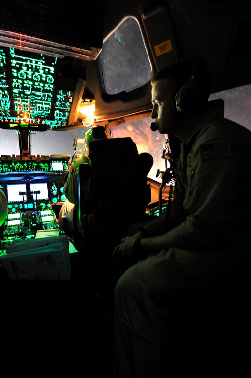 Airmen from 17th Airlift Squadron perform pre-flight procedures in a C-17 Globemaster III for a flight from Kandahar Airfield, Afghanistan, to Mihail Kogalniceanu Air Base, Romania, May 20.  Several C-17s are temporarily deployed to MK from another base in the region that is closed for routine runway repairs.  (U.S. Air Force photo by Master Sgt. Laura K. Deckman/released)