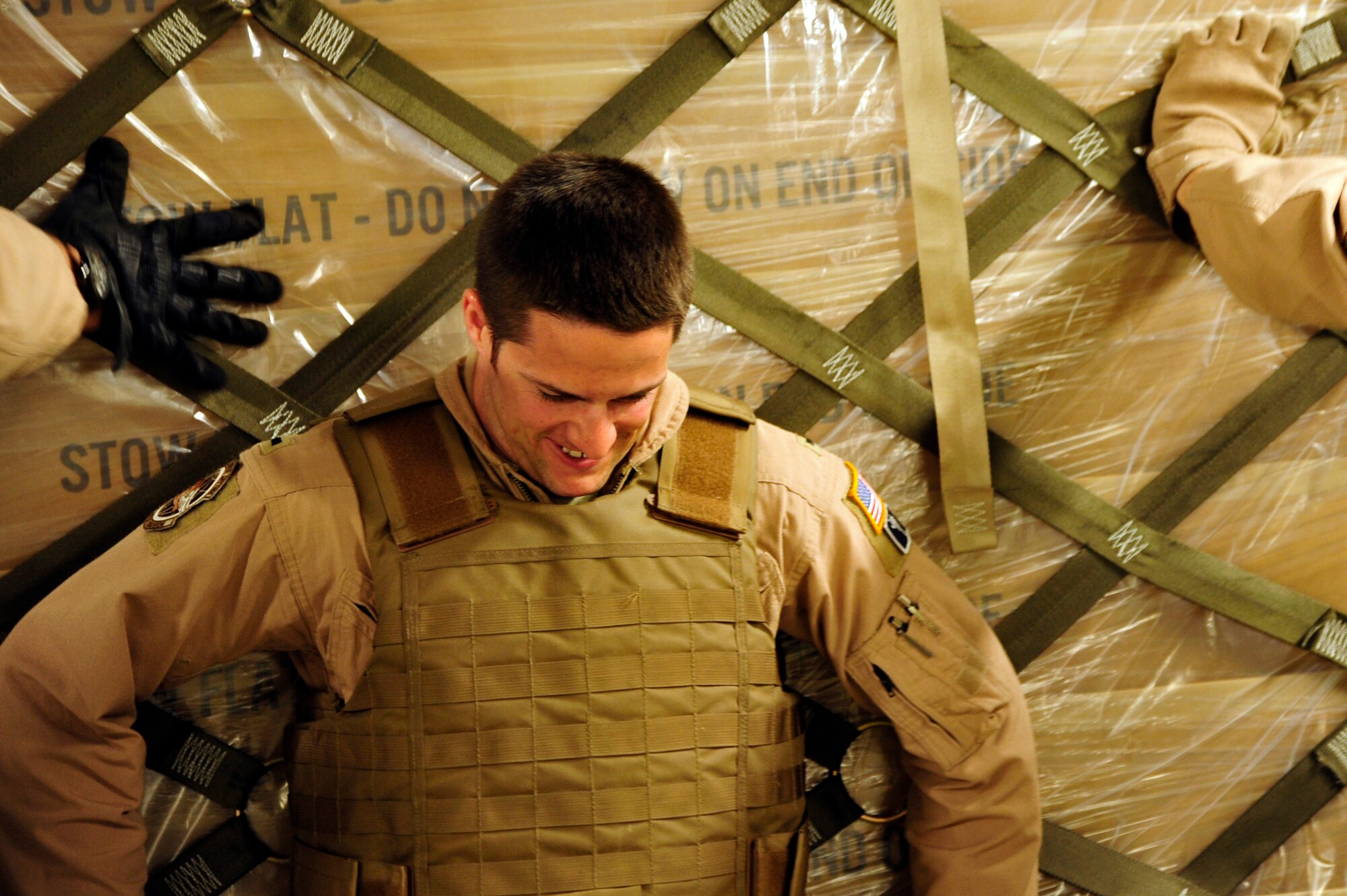 1st Lt. Christopher Dunlap, co-pilot with the 17th Airlift Squadron from Charleston Air Force Base, S.C., pushes cargo off a C-17 Globemaster III at Kandahar Airfield, Afghanistan, after a flight from Mihail Kogalniceanu Air Base, Romania, May 20.  The crew flew from MK airfield to Kandahar Airfield, Afghanistan carrying critical cargo supporting Operation Enduring Freedom.  Several C-17s are temporarily deployed to MK from another base in the region that is closed for routine runway repairs.  (U.S. Air Force photo by Master Sgt. Laura K. Deckman/released)