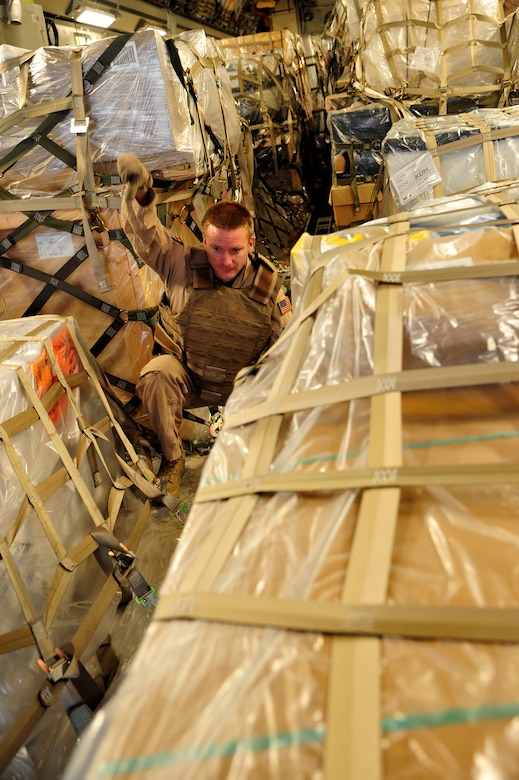 Staff Sgt. Doug Tadevich, 17th Airlift Squadron loadmaster, conducts cargo off-load operations at Kandahar Airfield, Afghanistan, after a flight from Mihail Kogalniceanu Air Base, Romania, May 20.  The crew flew a C-17 Globemaster III from MK airfield to Kandahar Air Base carrying critical cargo supporting Operation Enduring Freedom.  Several C-17s are temporarily deployed to MK from another base in the region that is closed for routine runway repairs.  (U.S. Air Force photo by Master Sgt. Laura K. Deckman/released)
