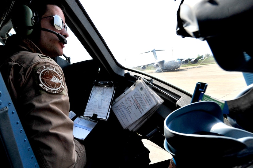 1st Lt. Christopher Dunlap, 17th Airlift Squadron co-pilot, prepares for flight in a C-17 Globemaster III at Mihail Kogalniceanu Air Base, Romania, May 20.  The crew flew from MK airfield to Kandahar Air Base, Afghanistan, carrying critical cargo supporting Operation Enduring Freedom.  Several C-17s are temporarily deployed to MK from another base in the region that is closed for routine runway repairs.  (U.S. Air Force photo by Master Sgt. Laura K. Deckman/released)