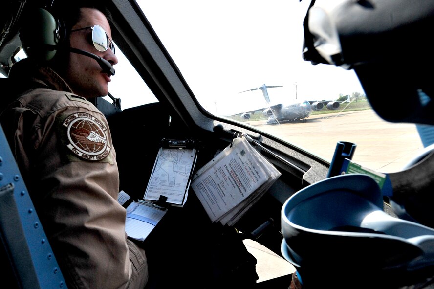 First Lt. Christopher Dunlap, 17th Airlift Squadron co-pilot, prepares for flight in a C-17 Globemaster III at Mihail Kogalniceanu Air Base, Romania, on May 20, 2011. The crew flew from MK airfield to Kandahar Air Base, Afghanistan, carrying critical cargo supporting Operation Enduring Freedom. Several C-17s are temporarily deployed to MK from another base in the region that is closed for routine runway repairs. (U.S. Air Force Photo/Master Sgt. Laura K. Deckman)