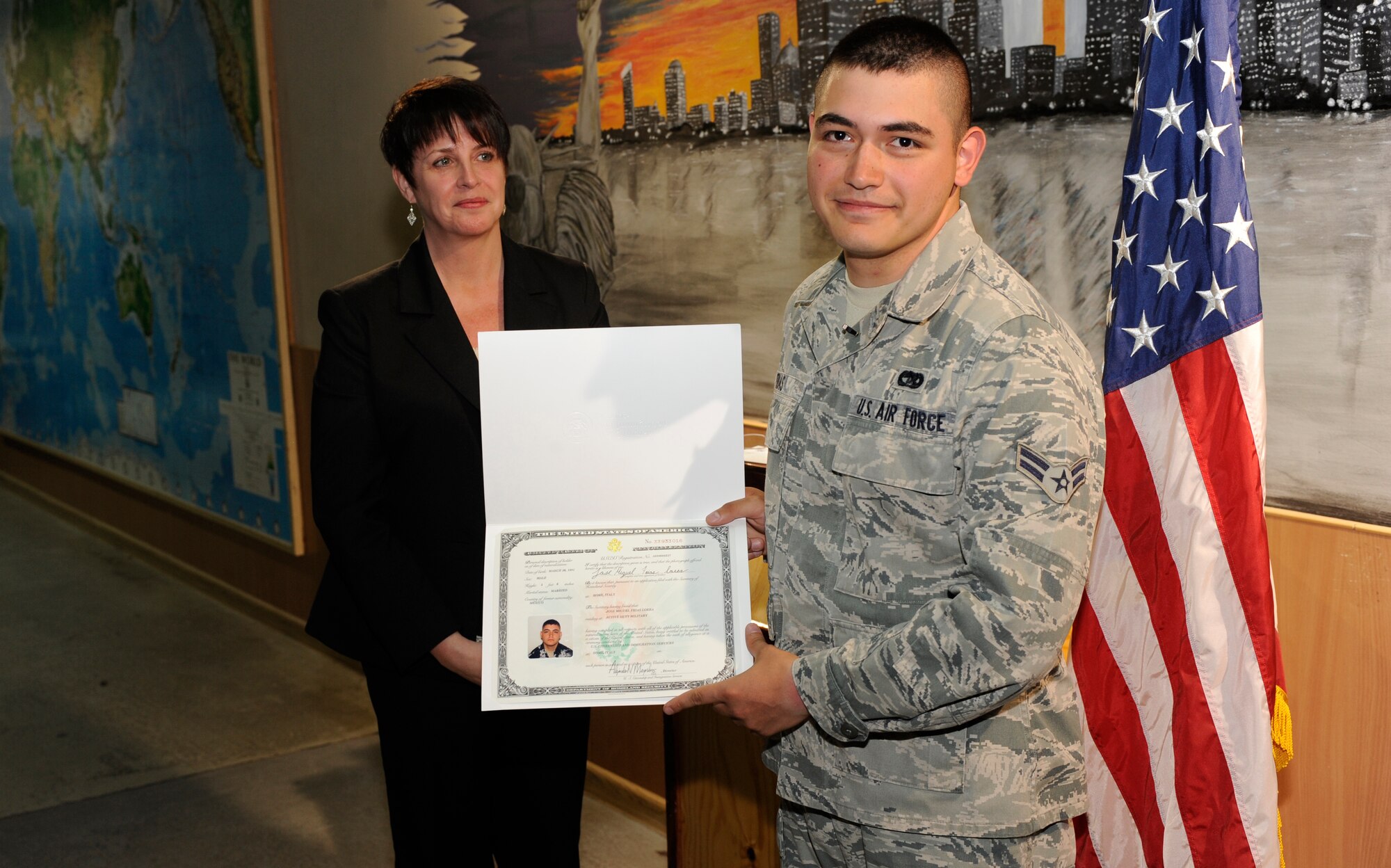 TRANSIT CENTER AT MANAS, Kyrgyzstan -- Airman 1st Class Jose Frias, 376th Expeditionary Logistics Readiness Squadron Passenger Terminal representative, celebrates his U.S. citizenship in the PAX terminal here May 25.  
Airman Frias, a Tampico, Mexico native and two-years time in service said he's excited to be the first in his family to earn U.S. citizenship. (U.S. Air Force photo by Tech. Sgt. Jerome C. Baysmore)