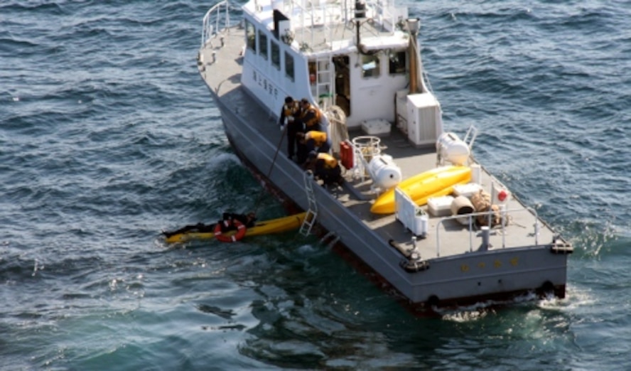 Members of the Japanese Coast Guard rescue kayakers from the Pacific Ocean in northern Japan May 23. Four people attached to Misawa Air Base went missing when they failed to return from an afternoon kayak trip the day before. A combined search operation with the U.S. military and Government of Japan found and rescued the kayakers approximately 10 miles off shore. (Photo courtesy of the Japanese Coast Guard)