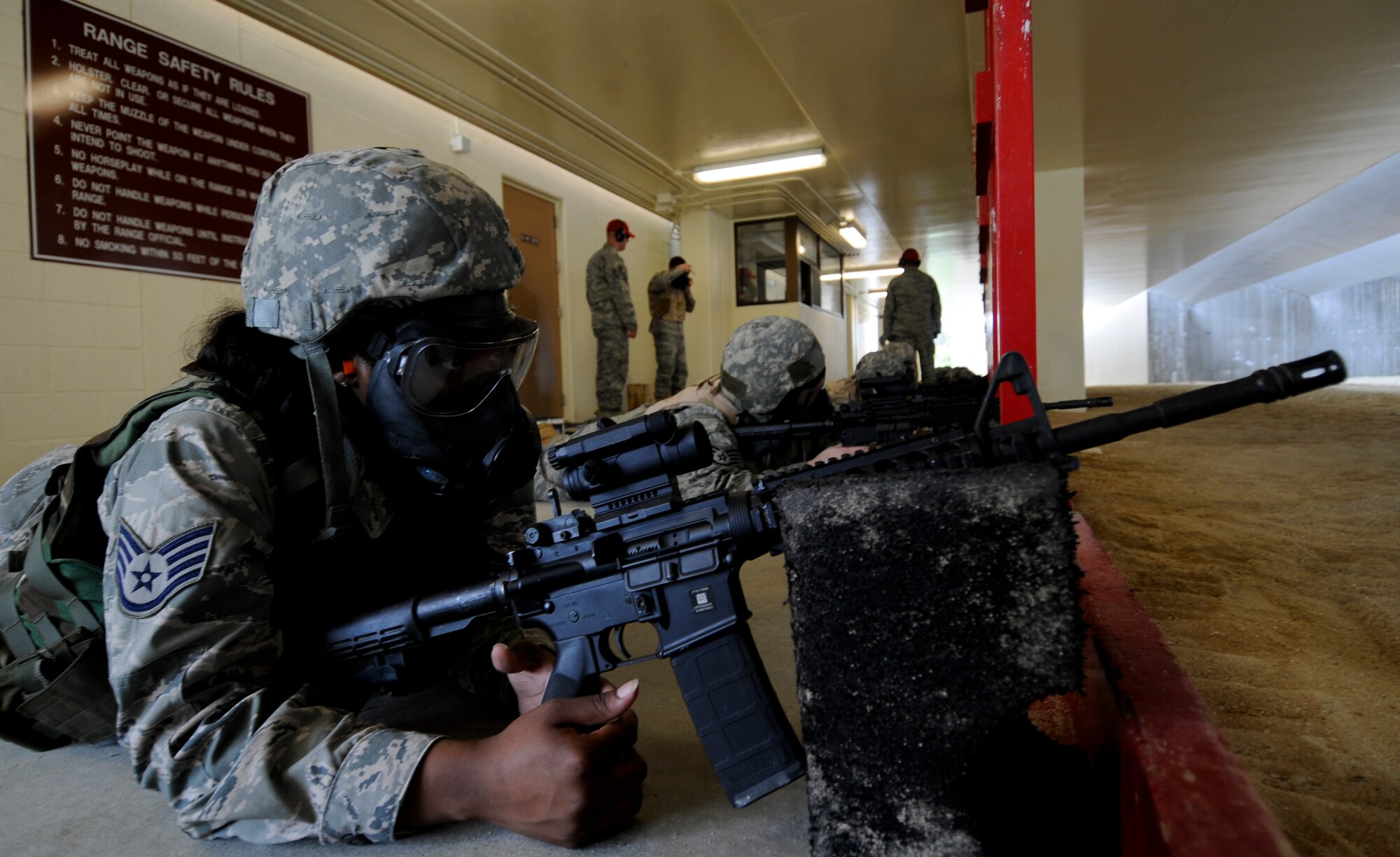 A qualifying Airman awaits the command of "fire" during the gas mask portion of the qualification at the 18th Security Forces Squadron's newly-refurbished Combat Arms firing range May 24. After a series of lengthy renovations to Kadena's old range, Airmen will no longer have to transfer from the security forces building's classroom on Kadena to the Marine Corps range on Camp Hansen, saving Kadena money in transportation costs, vehicle maintenance and man-hours. (U.S. Air Force photo/ Airman 1st Class Maeson L. Elleman)